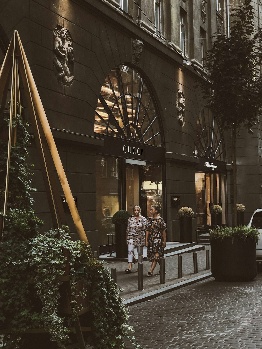 a couple of people that are standing in front of a building