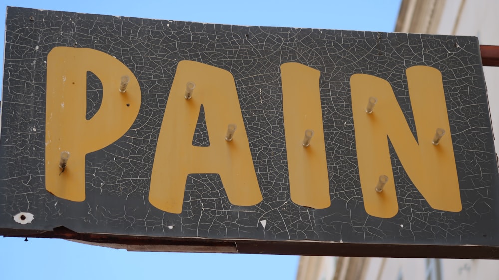 black and brown Pain signboard