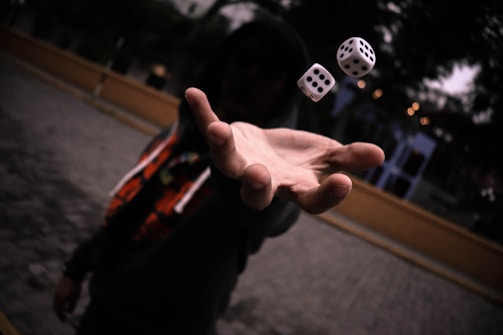 left human hand rolling dice