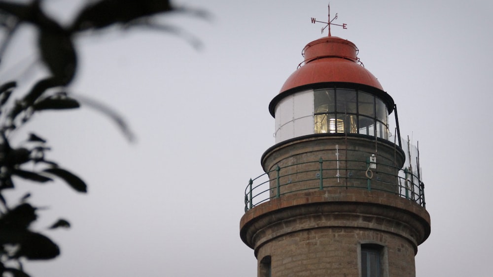 brown and red lighthouse during daytime