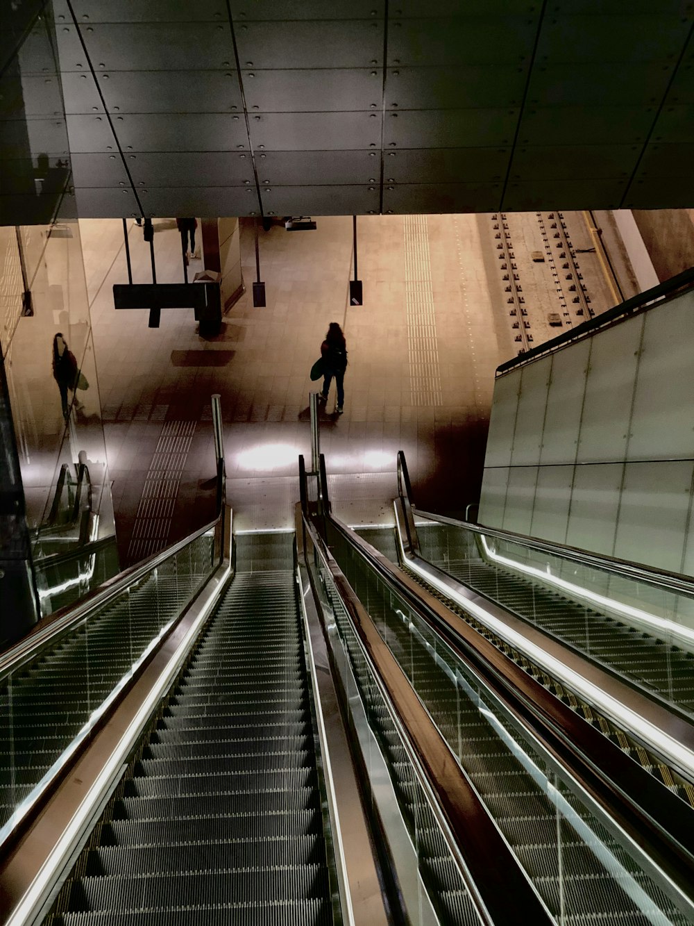 woman standing near escalators