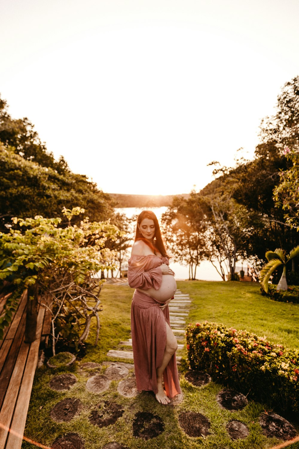 pregnant woman standing near trees