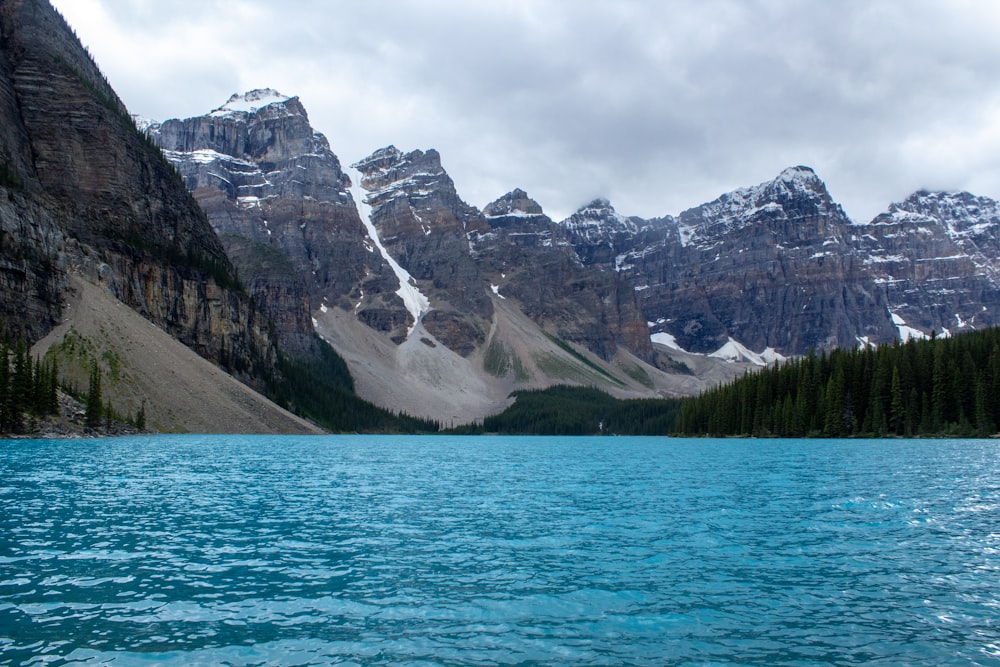 blue body of water with mountain background