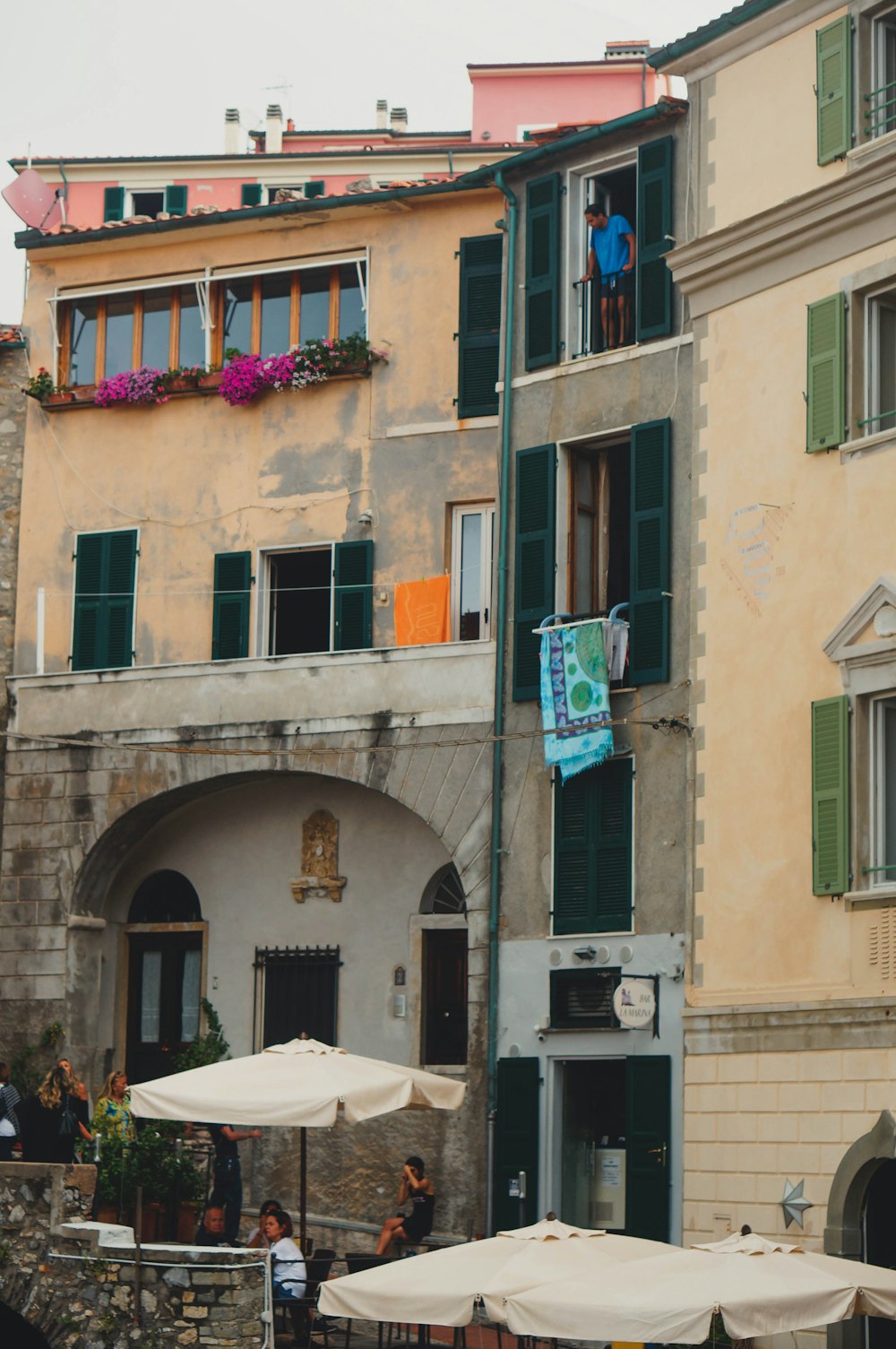 a group of people sitting at tables in front of a building