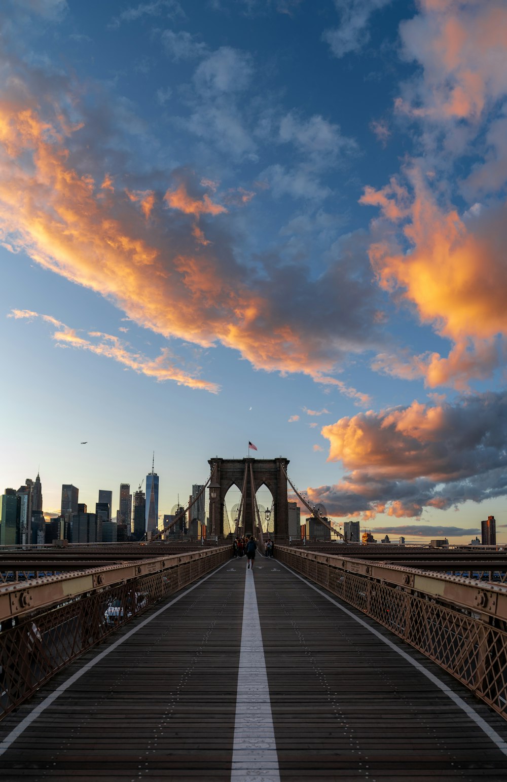 Brooklyn Bridge in New York City under blue and orange skies during daytime