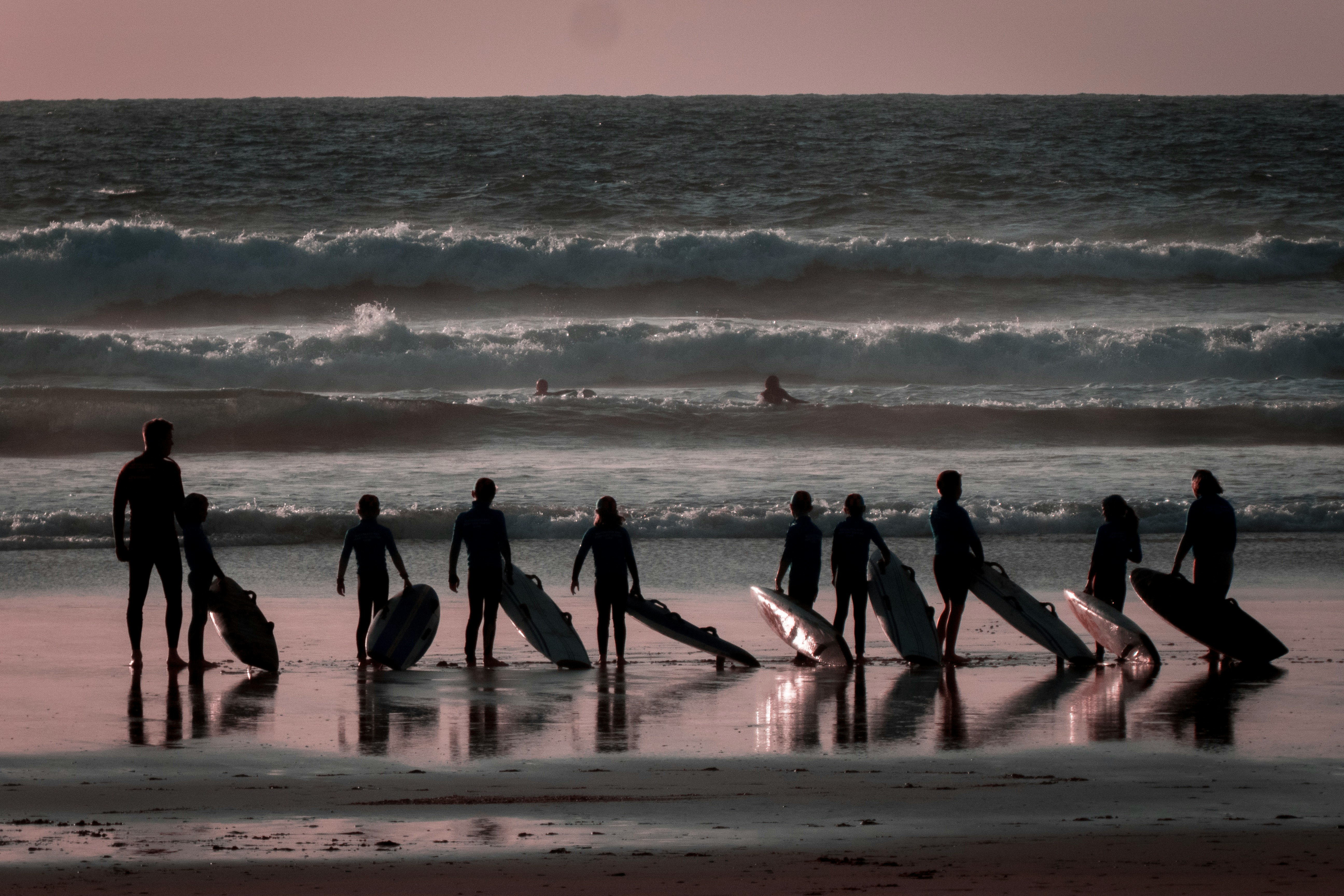 person holding surfboards