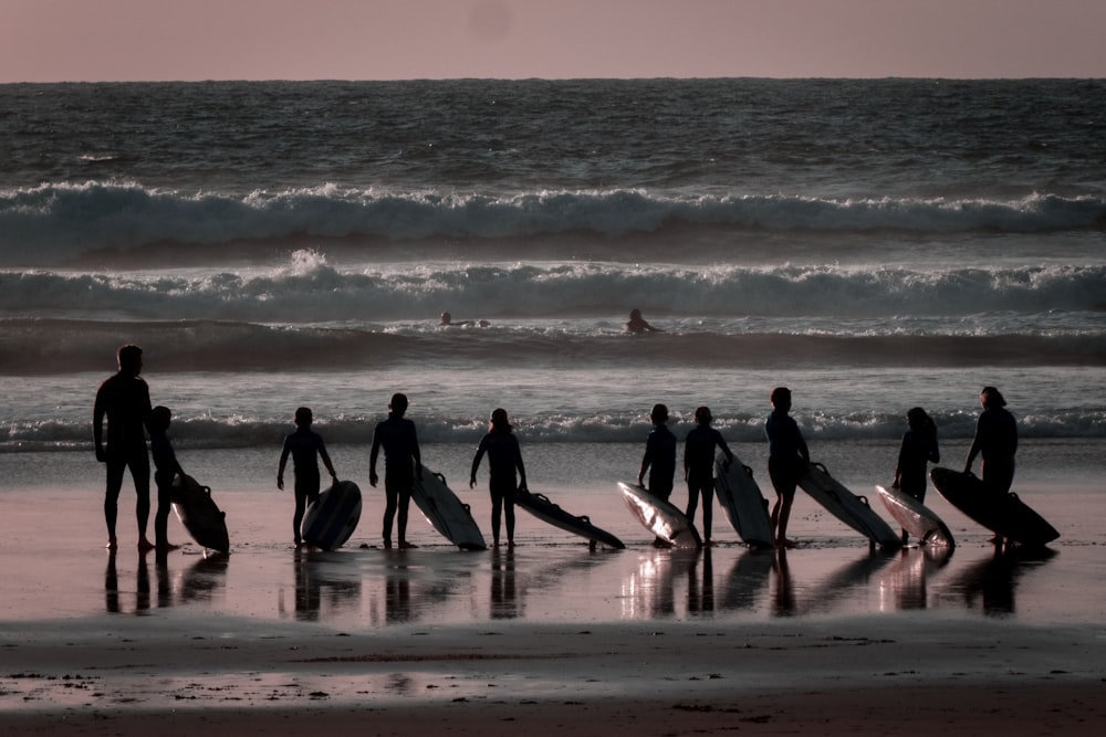 person holding surfboards