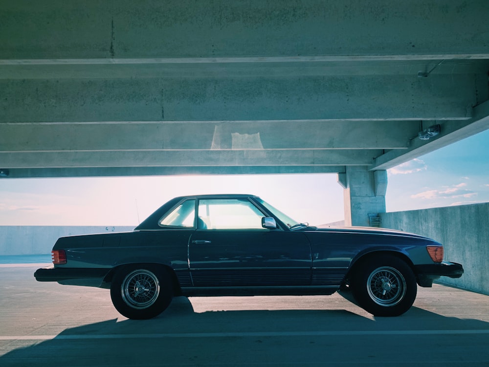 gray coupe parked in indoor parking lot