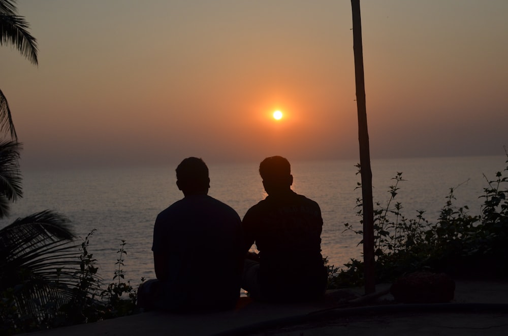 two persons looking at sea