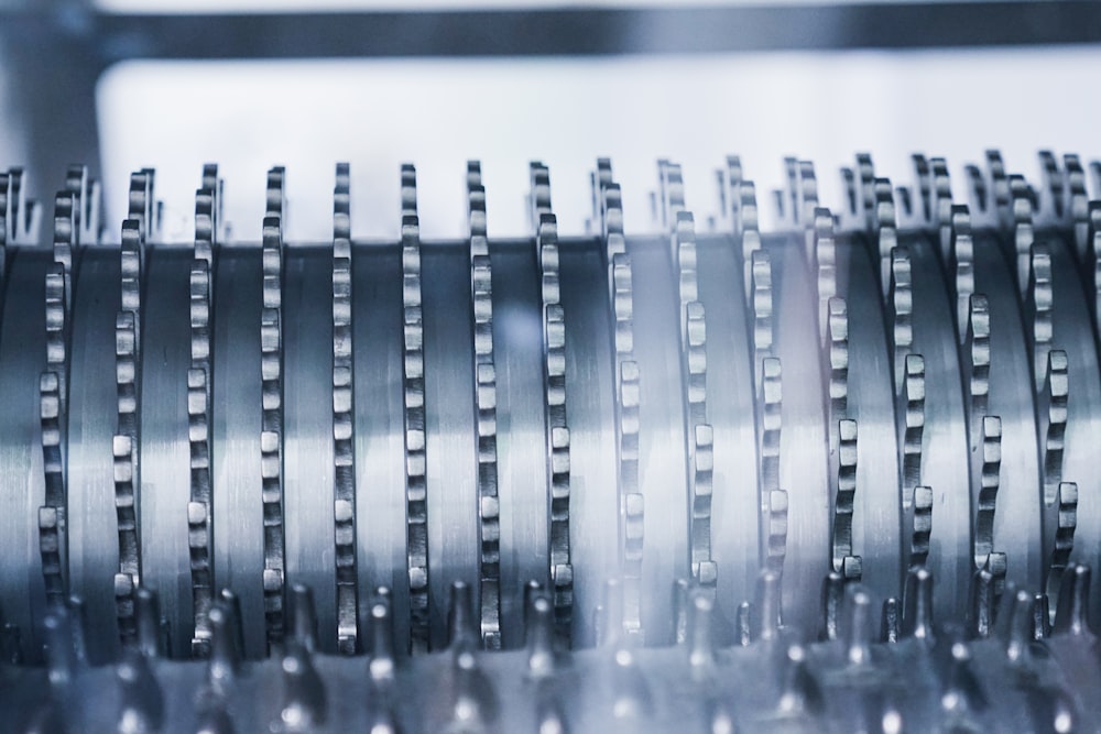 a close up of a machine that is making metal parts