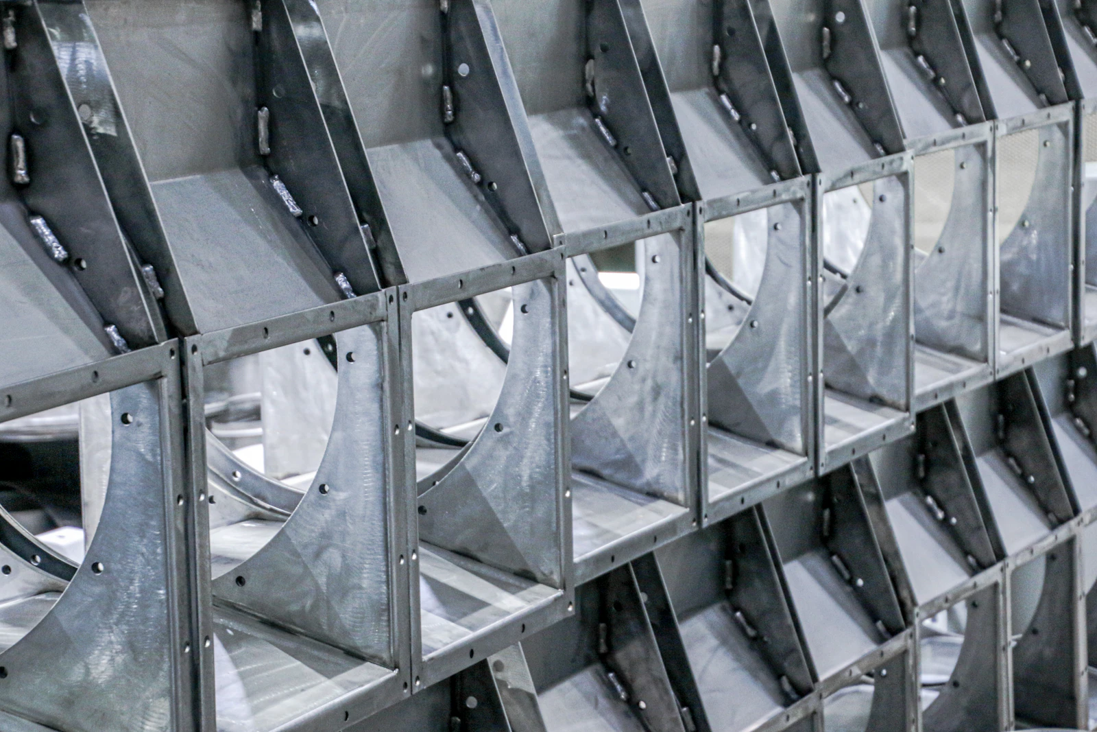 Rows of custom-fabricated sheet metal components in a fabrication shop
