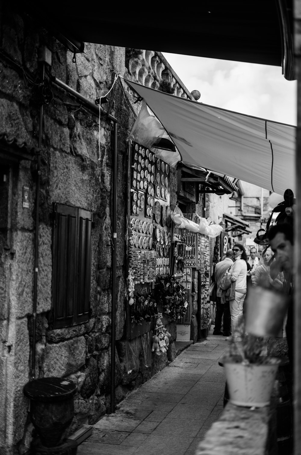 a black and white photo of people walking down a street