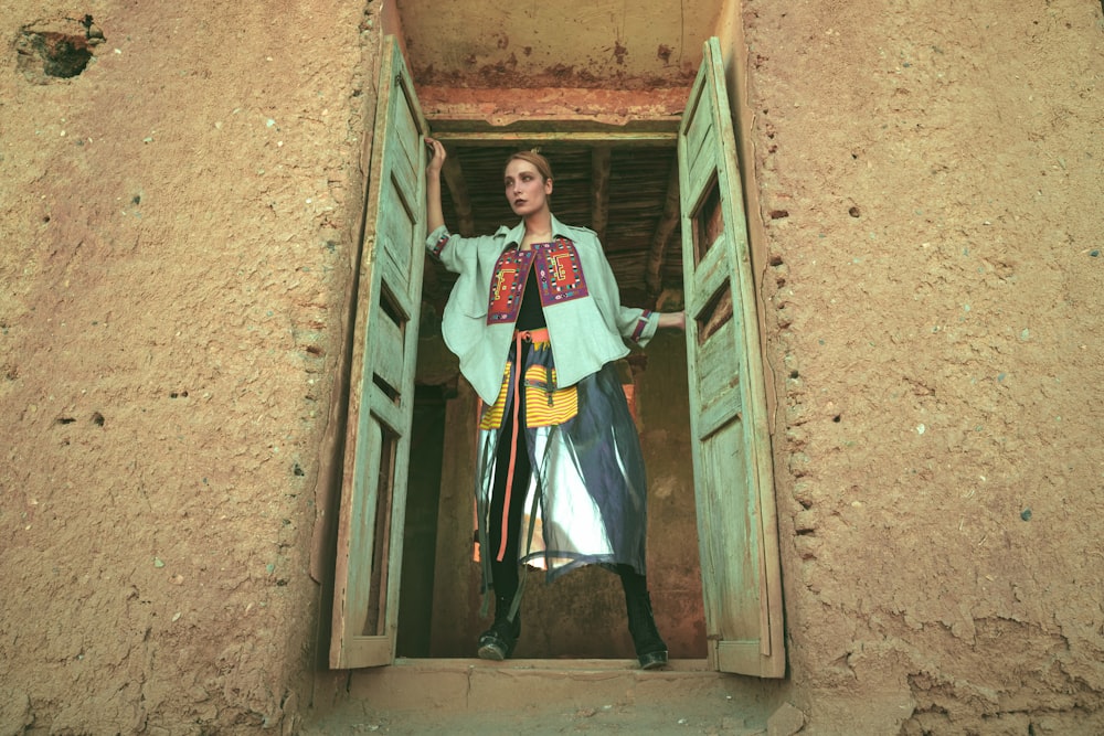 woman standing on opened window