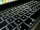 Close-up of a laptop keyboard with glowing keys.