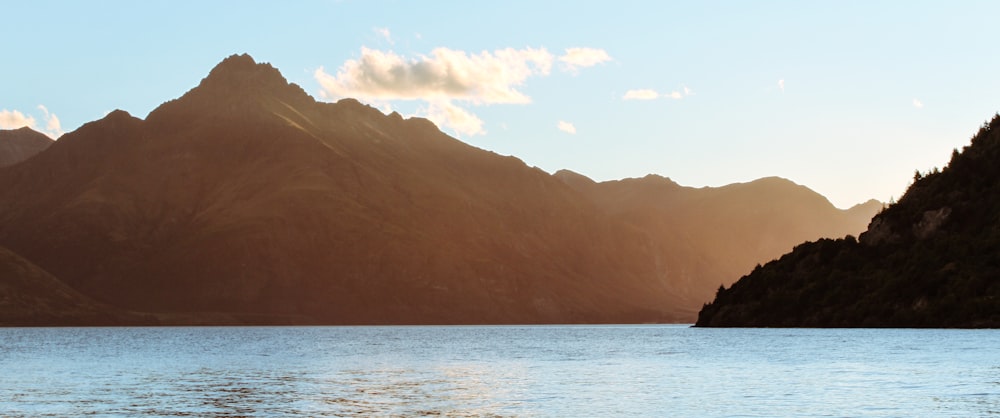 mountain beside calm body of water