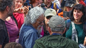 A candid shot of Elder Martins engaging with community members during a service event