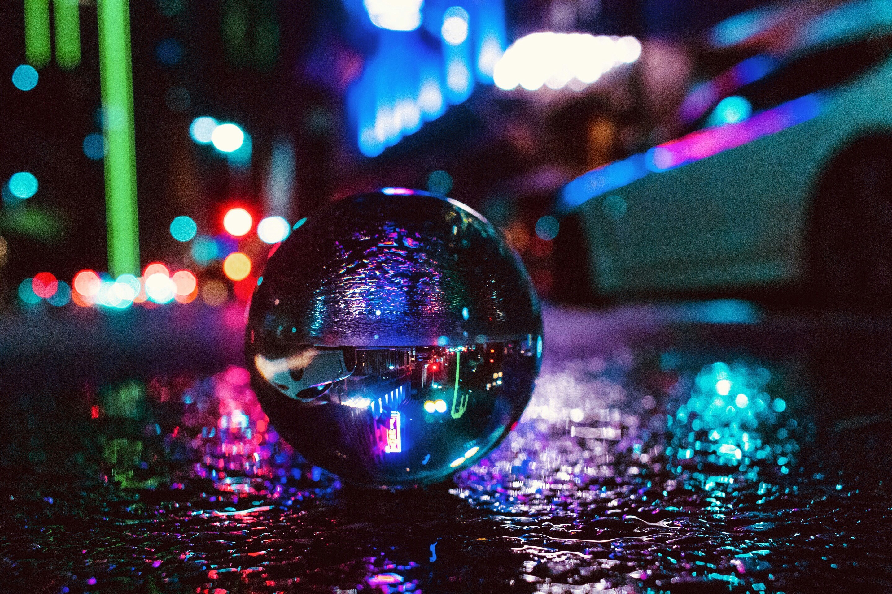 Glass Ball Photography On Ground Near Vehicle With Lights During Nighttime Photo Free Image On Unsplash