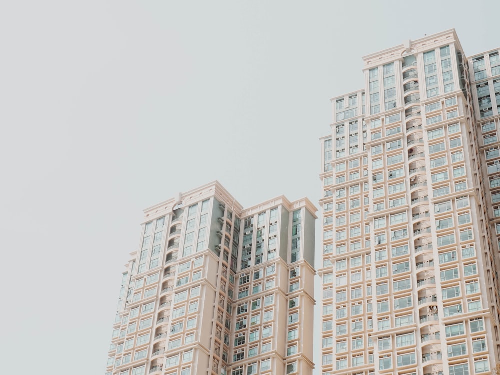 low-angle photography of white high-rise buildings