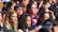 A diverse group of people engaged in a lively makeup workshop.