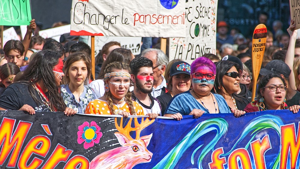 crowd of people rallying during daytime