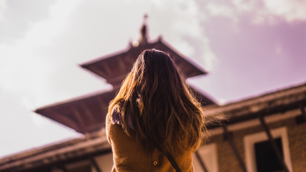 woman standing beside buildding