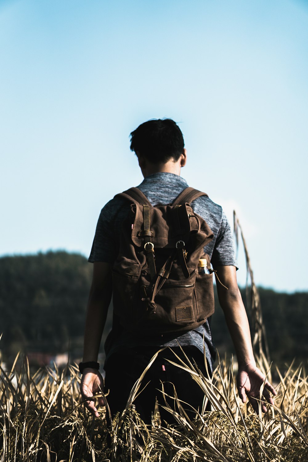 man wearing brown backpack