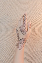 A welcoming contact page with henna designs.