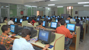 Brightly lit computer lab where students focus on their studies