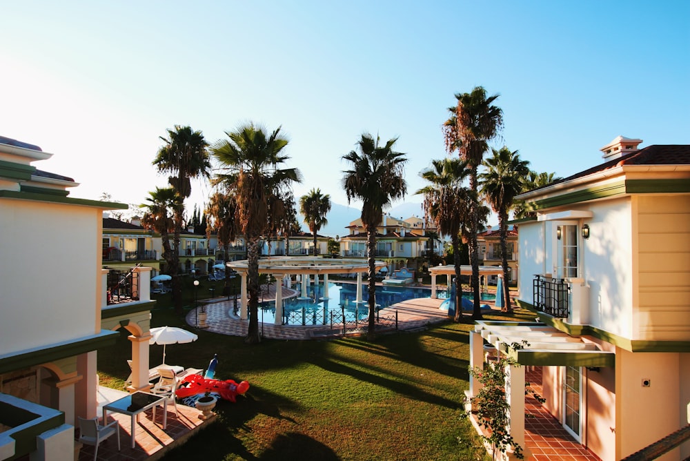 white buildings and hotel near swimming pool during daytime