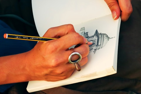 person sketching building