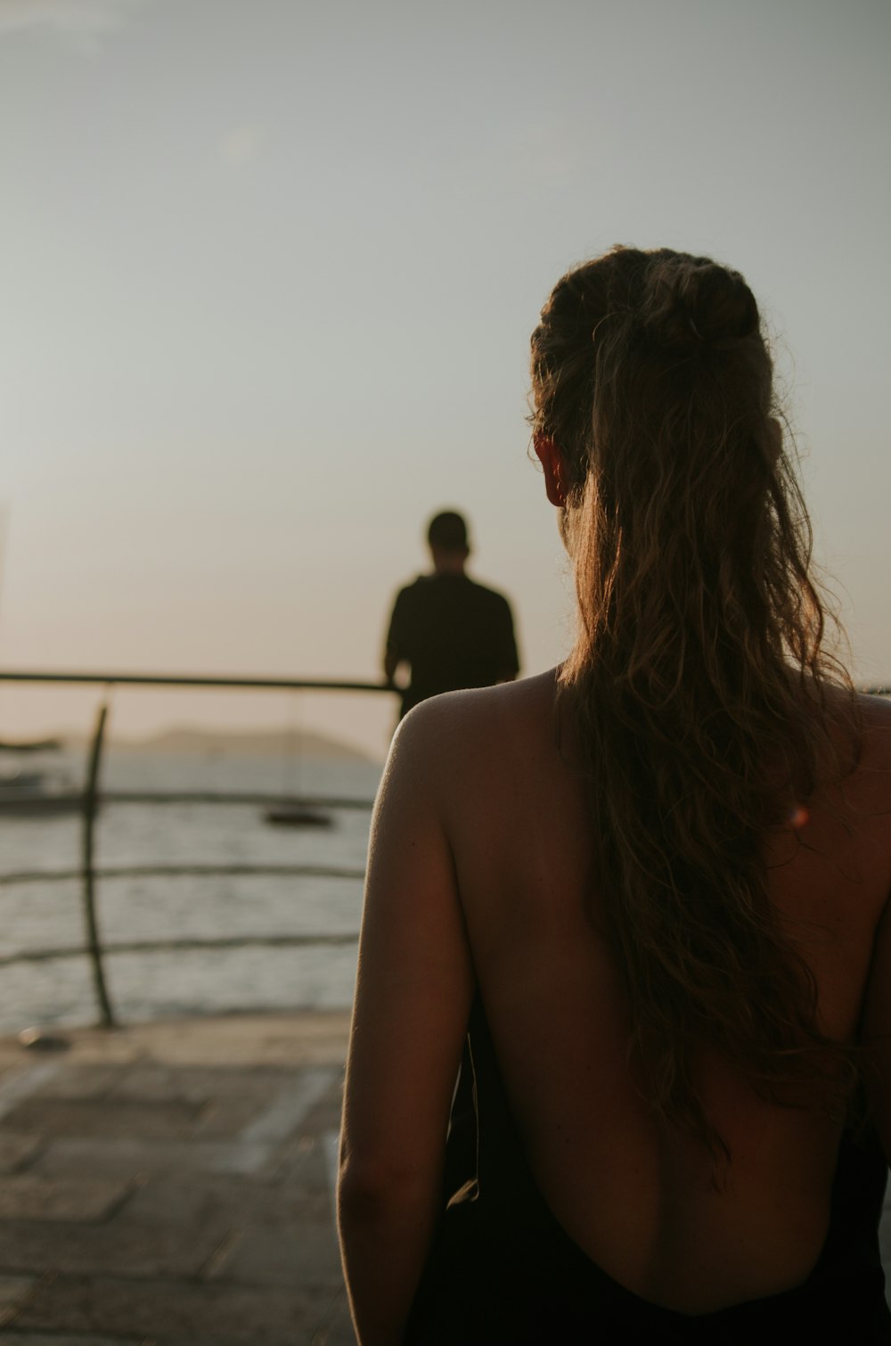 selective focus photography of woman facing on body of water