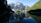 A serene view of the mountains reflecting in a tranquil reservoir.