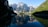 A serene view of the mountains reflecting in a tranquil reservoir.