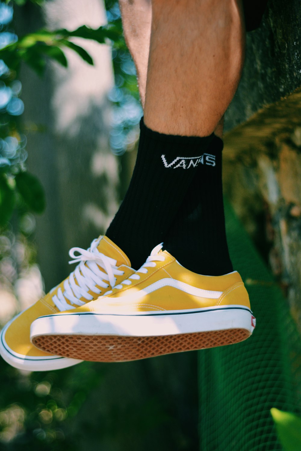 pair of yellow-and-white Vans low-top shoes