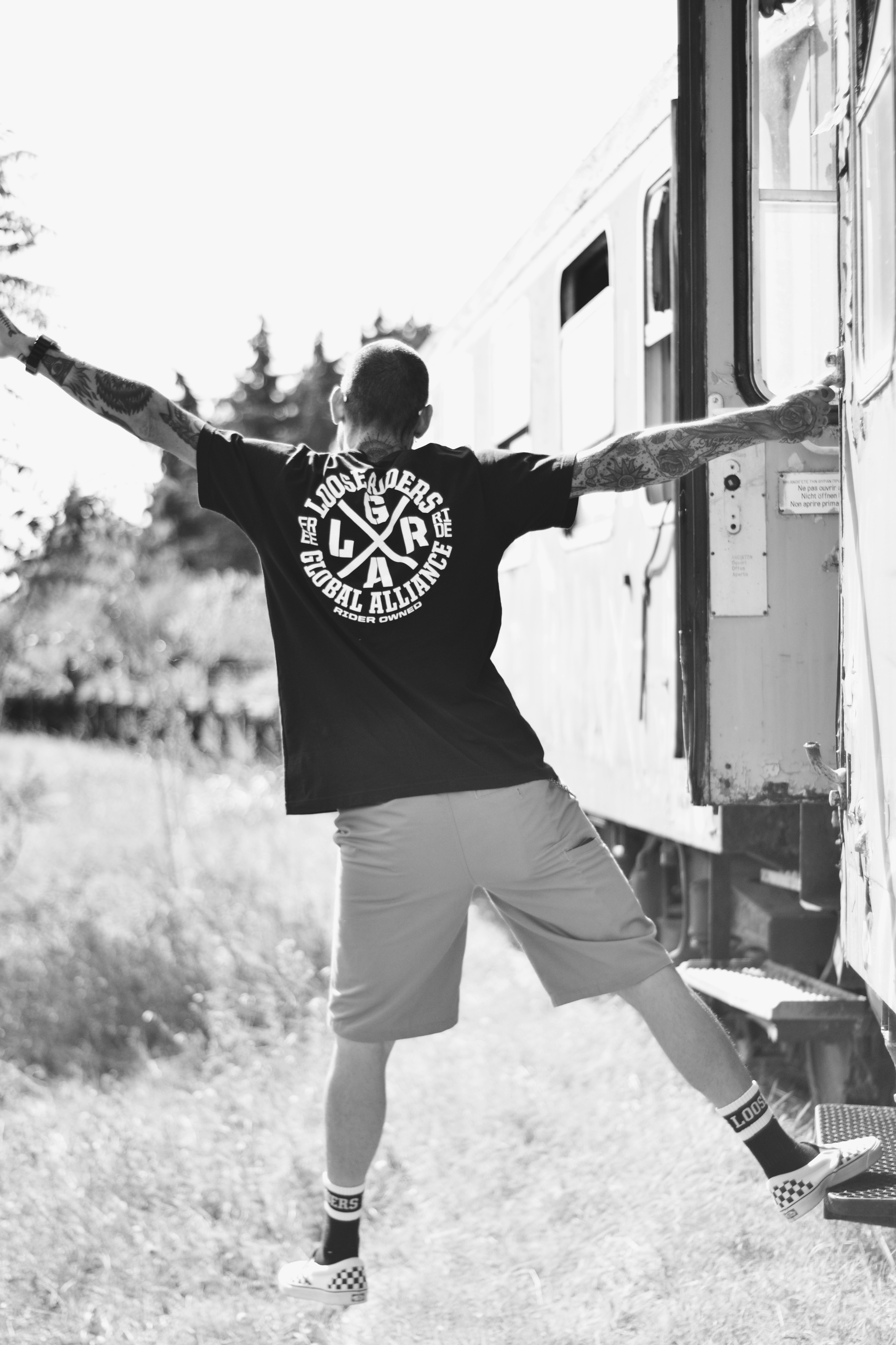 gray-scale photo of man wearing shirt