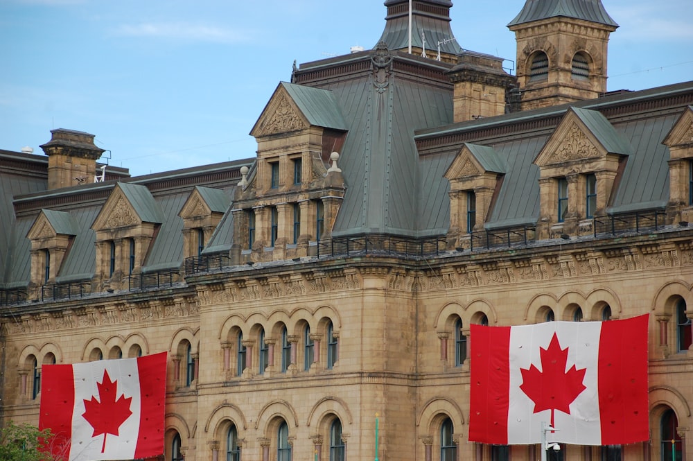 Canada flags hanging on concrete castle wall