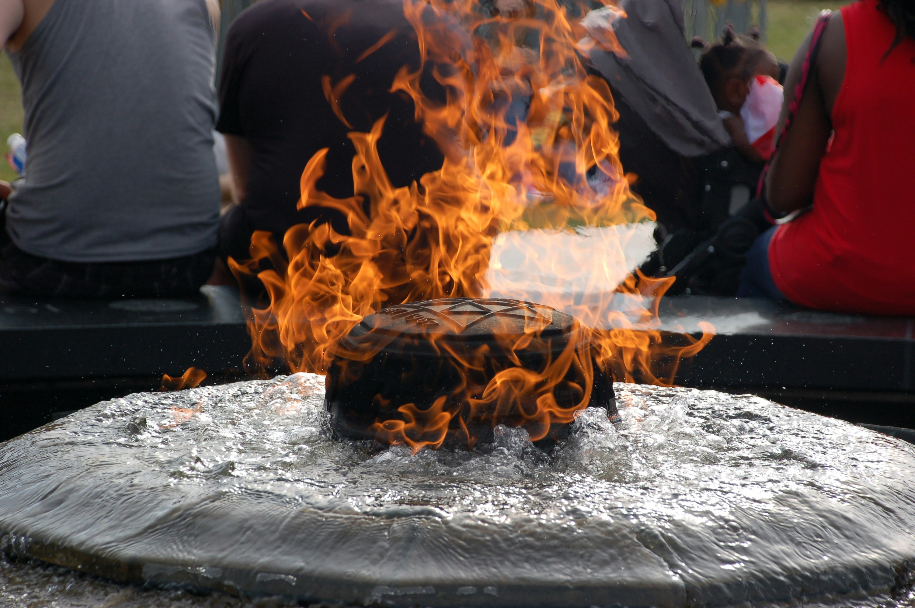 burning black ornament near people sitting on chairs