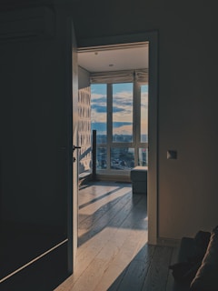 ottoman near window behind opened door