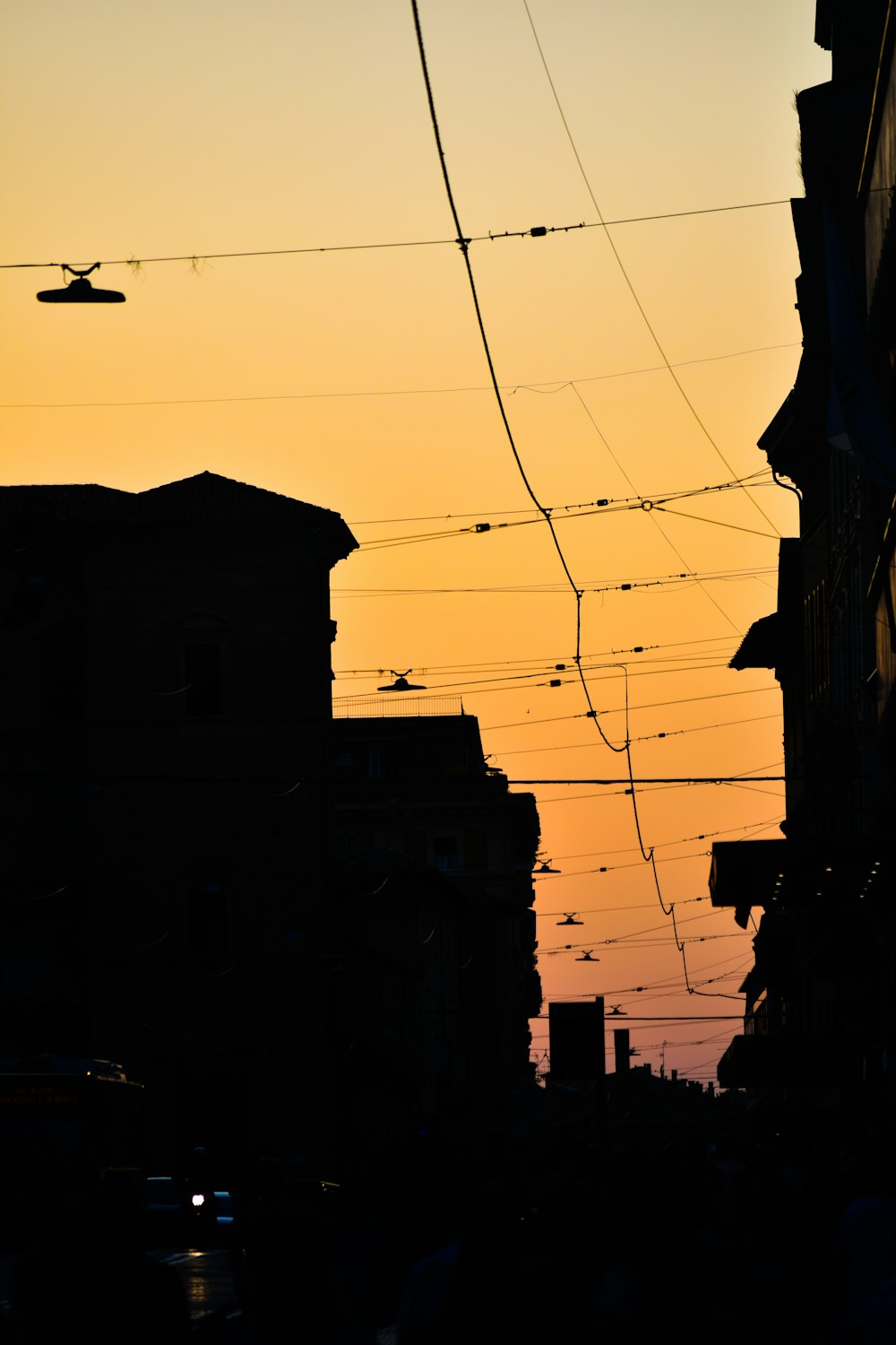 a city street at sunset with power lines above
