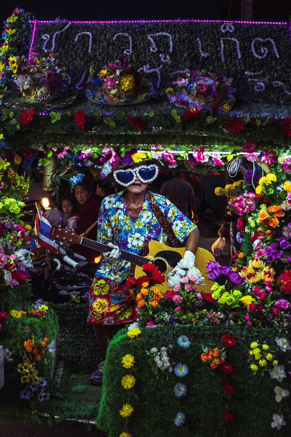 pessoa tocando guitarra em roupas multicoloridas