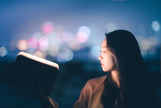 woman opening a notepad with light