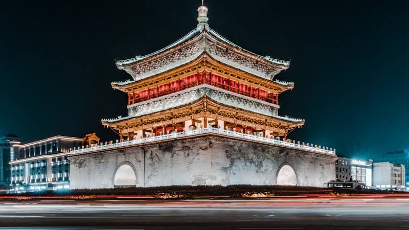 snow-covered xian city wall with traditional tower and walking tourists