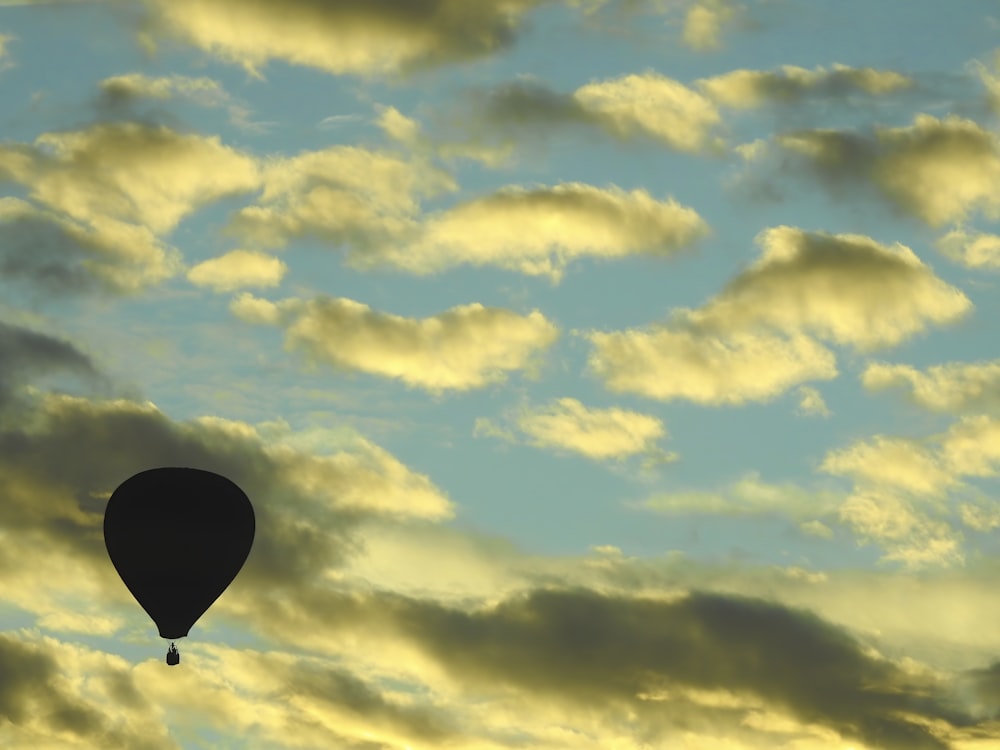 hot air balloon on mid air under cloudy sky