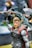 A highly detailed action figure of a superhero character wearing an armor with red accents and a cape. The figure holds an intricately designed hammer and has a focused expression. The background is blurred, highlighting the figure in the foreground.