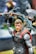 A highly detailed action figure of a superhero character wearing an armor with red accents and a cape. The figure holds an intricately designed hammer and has a focused expression. The background is blurred, highlighting the figure in the foreground.
