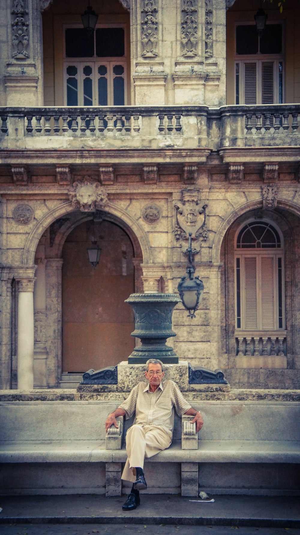 sitting man wearing white dress shirt during daytime