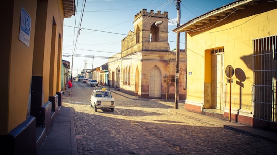 car passing by a street in a village in Trinidad Cuba
