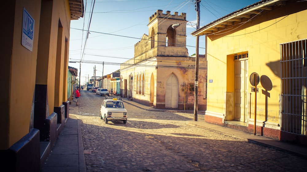 car passing by a street in a village