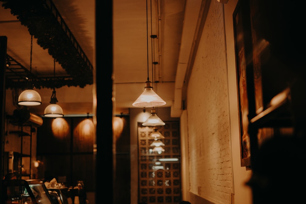 a dimly lit room with several lights hanging from the ceiling