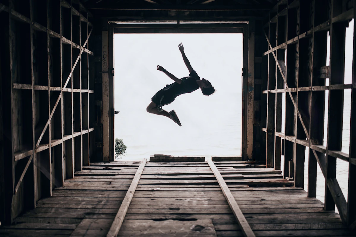 A boy doing a parkour flip